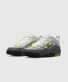 White, grey, and neon green low-top sneakers with black accents on a white background.