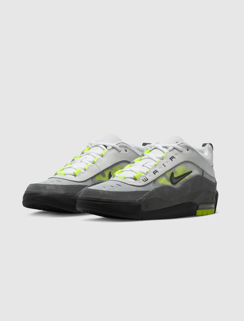 White, grey, and neon green low-top sneakers with black accents on a white background.