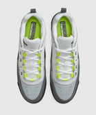 Top view of grey and white athletic sneakers with neon yellow accents and white laces