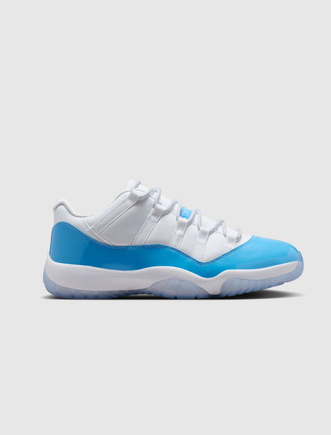 White and blue low-top sneaker with patent leather accents on a neutral background