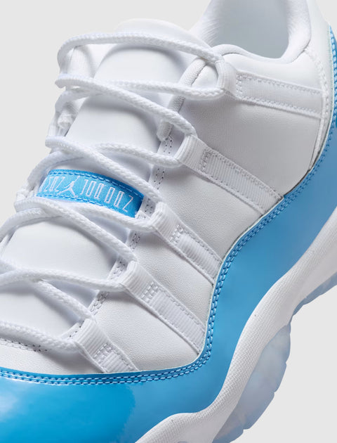 Close-up of white and light blue low-top sneaker with white laces and glossy accents