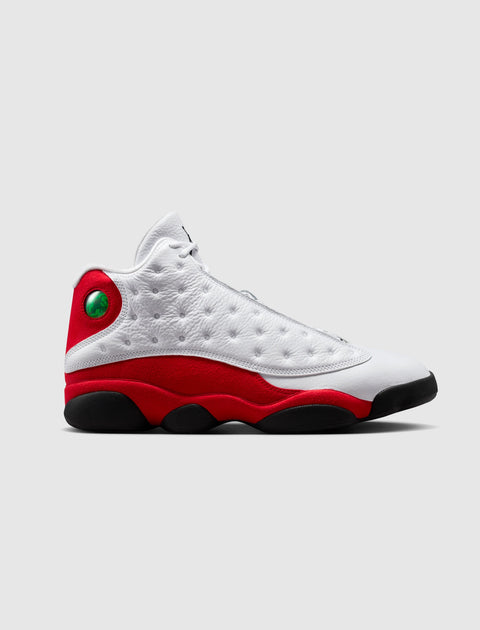 White and red high-top sneaker with black sole and green holographic detail