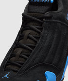 Close-up of black and blue suede sneaker with visible Jordan branding and laces
