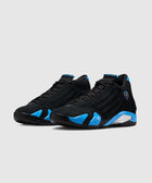 Black and blue suede athletic sneakers with low profile and side detailing on a white background
