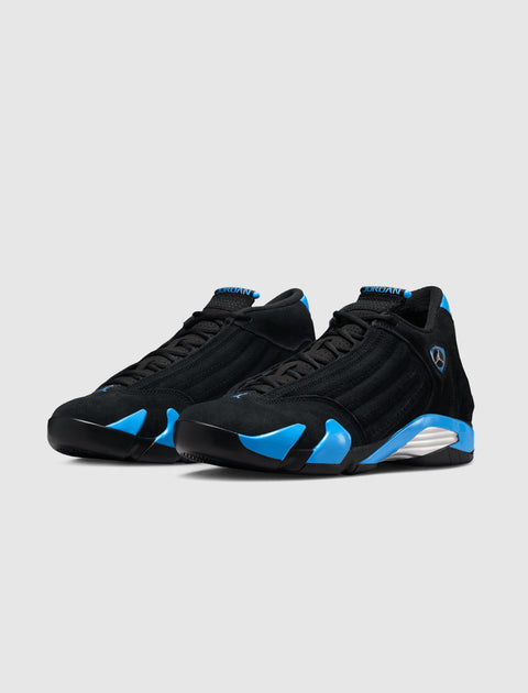 Black and blue suede athletic sneakers with low profile and side detailing on a white background