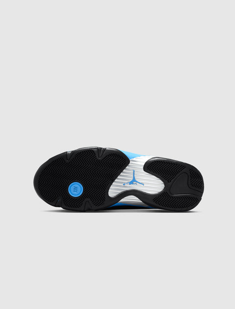 Bottom view of a sneaker with black, white, and blue sole, visible Jumpman logo, herringbone tread