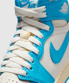 Close-up of white and blue high-top sneaker with white laces and Nike Air logo on tongue