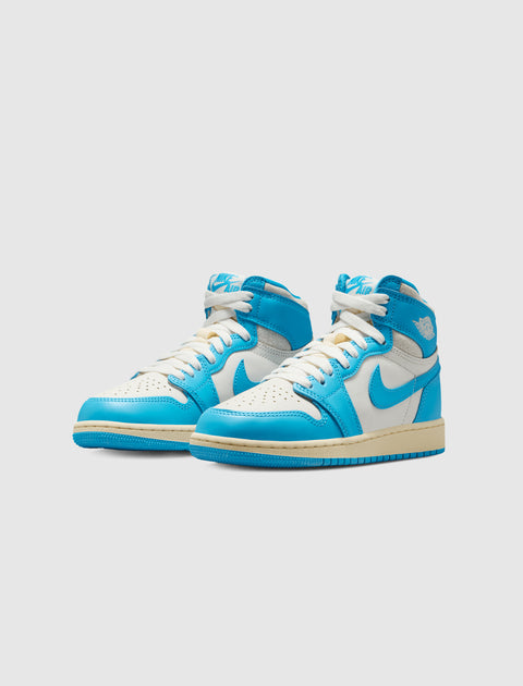 White and blue high-top sneakers with beige soles on a plain background