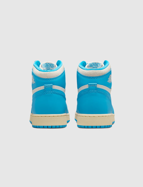 Back view of blue high-top sneakers with white trim and cream sole on white background