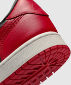 Close-up of red and white leather sneaker heel and outsole with textured tread