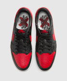Black and red low-top sneakers with text graphic insoles, Nike swoosh logo visible