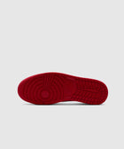 Red rubber sneaker outsole with concentric circle traction pattern on a light background