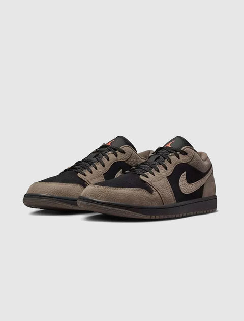 Black and olive grey low-top sneakers with suede and leather panels on a white background