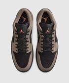 Black and olive low-top sneakers with suede panels and red logo on tongue, top view