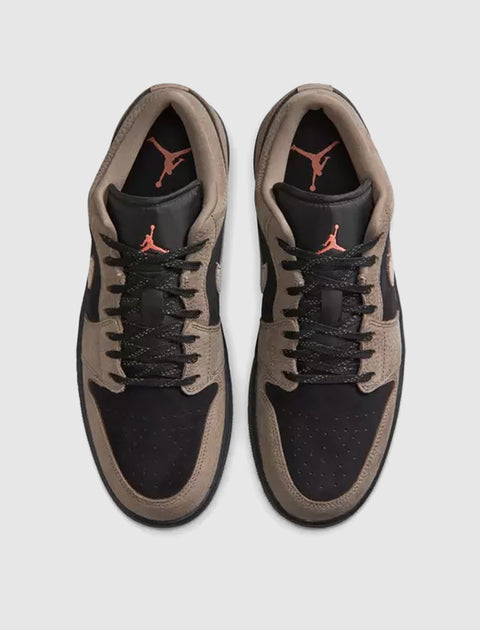 Black and olive low-top sneakers with suede panels and red logo on tongue, top view