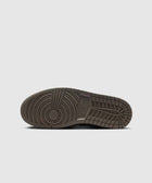 Brown rubber sneaker sole with circular tread pattern, displayed on a white background.