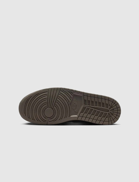 Brown rubber sneaker sole with circular tread pattern, displayed on a white background.