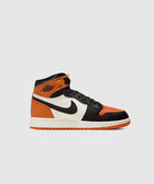 High-top sneaker with black, orange, and white color blocking on a light background