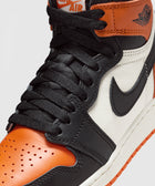 Close-up of Nike Air Jordan 1 sneaker in black, orange, and white leather