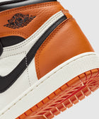 Close-up of Air Jordan 1 sneaker in orange, white, and black leather with embossed logo