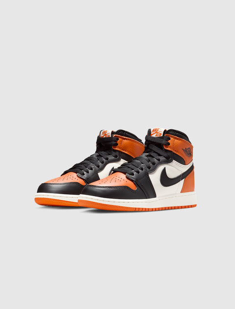 Black, orange, and white high-top sneakers with Nike swoosh logo on clean background