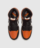 Top view of high-top sneakers with orange, black, and white leather panels and black laces