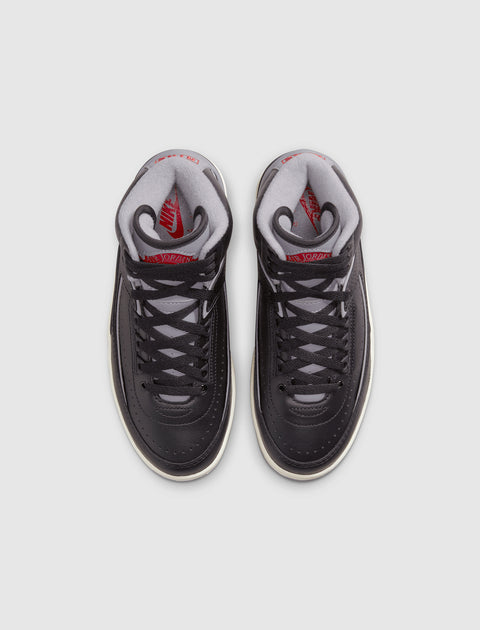 Black and grey high-top sneakers with red accents, viewed from above on white background