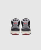 Back view of black and grey high-top sneakers with red NIKE logo and red rubber soles