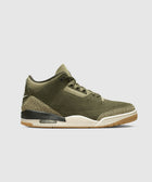 Olive green sneaker with crackle print accents, air sole, and white midsole on gray background.