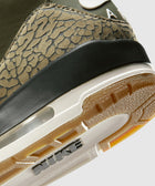 Close-up of sneaker heel with camouflage texture, rubber outsole, visible Nike branding