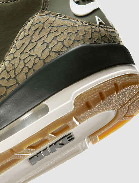 Close-up of sneaker heel with camouflage texture, rubber outsole, visible Nike branding