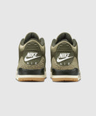 Olive green Nike Air sneakers with gum sole and elephant print heel, rear view.