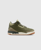 Olive green sneaker with suede upper, camouflage accents, and gum sole on white background