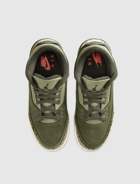 Olive green Nike Air sneakers with suede uppers and patterned midsoles, top view