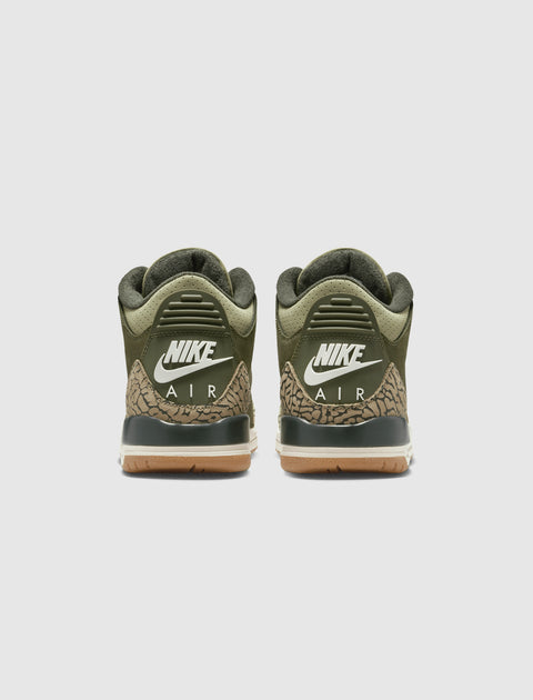 Back view of olive green Nike Air sneakers with camouflage and gum soles