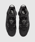 Top view of black Nike Air Jordan sneakers with white logo details on a grey background