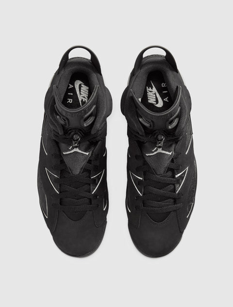 Top view of black Nike Air Jordan sneakers with white logo details on a grey background