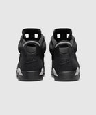 Rear view of black Nike Air sneakers with grey accents on heels, displayed on white background.