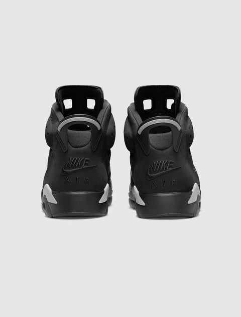 Rear view of black Nike Air sneakers with grey accents on heels, displayed on white background.