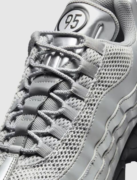 close-up of silver mesh and synthetic men's sneaker with '95' logo on tongue