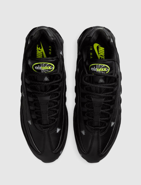Black Nike Air Max 95 sneakers with spider and web Halloween accents, neon branding, top view