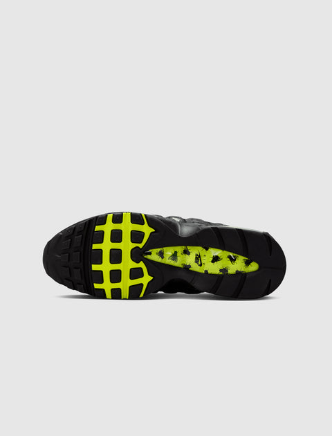 Black and neon sneaker outsole with bug graphic details and Nike logo