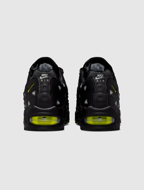 Black Nike Air Max 95 sneakers with neon green sole and Halloween-inspired details, rear view