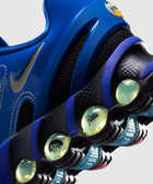 Close-up of a blue sneaker with visible air cushioning, mesh, and logo details