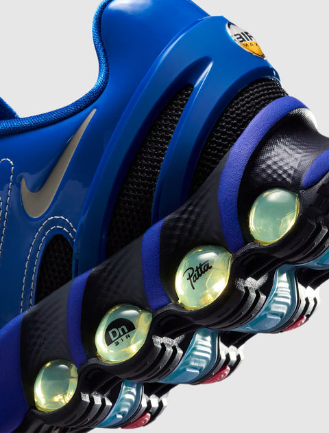Close-up of a blue sneaker with visible air cushioning, mesh, and logo details