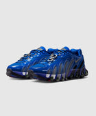 Blue low-top sneakers with wavy patterns, mesh panels, and unique cushioned soles