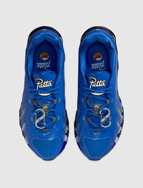 Top view of blue Patta Nike Air Max sneakers with silver accents on a gray background