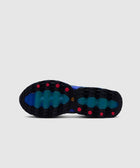 Blue sneaker outsole with black tread, teal accents, and red grip details on white background