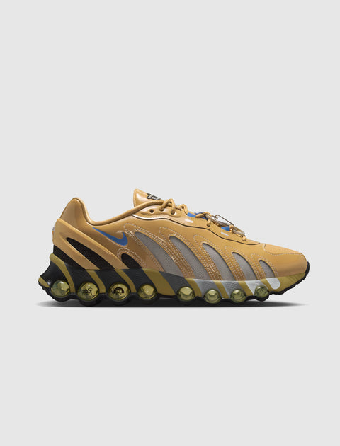 Tan and yellow sneaker with mesh panels, visible air pods, and a blue swoosh logo on the side