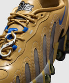 Close-up of tan and mesh men's streetwear sneaker with blue swoosh and unique lace hook.
